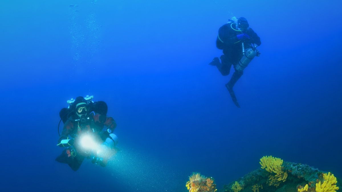 Technical diver exploring underwater cave overhead environment