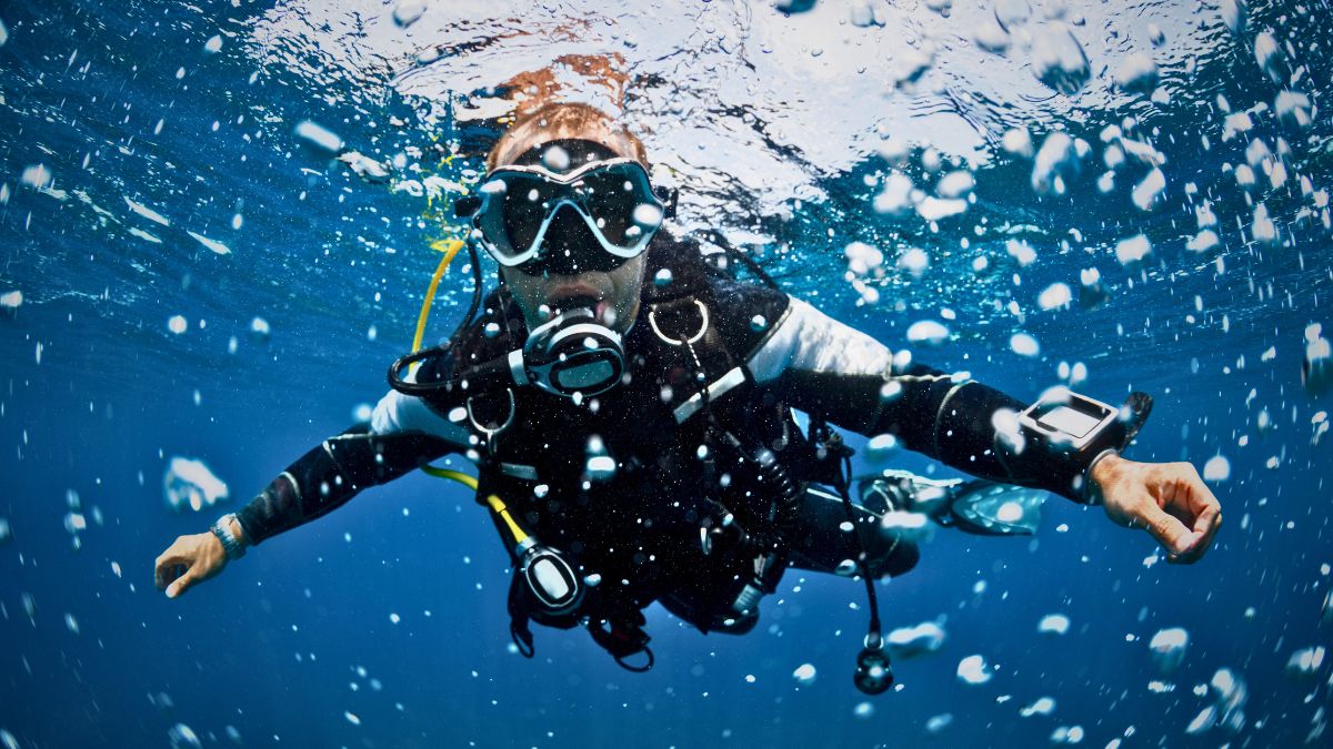 PADI Advanced student practicing deep dive specialty with instructor checking dive computer in Costa Rica showing advanced certification training course