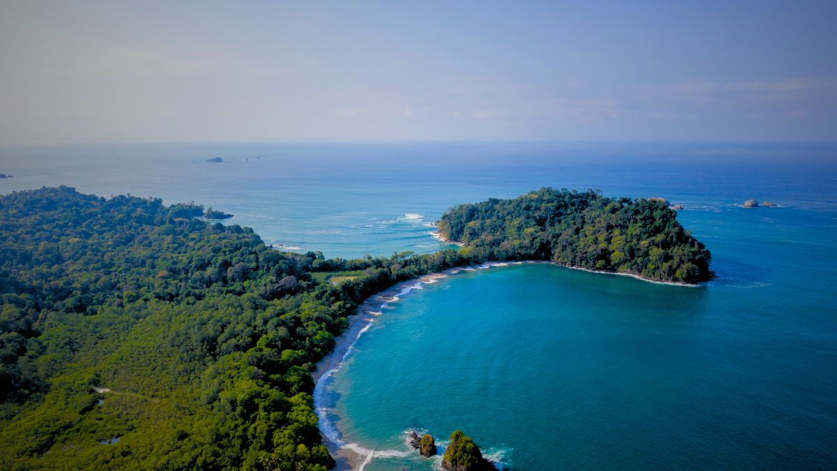 Beginner scuba diver with instructor exploring colorful underwater marine life in crystal clear waters of Manuel Antonio Costa Rica