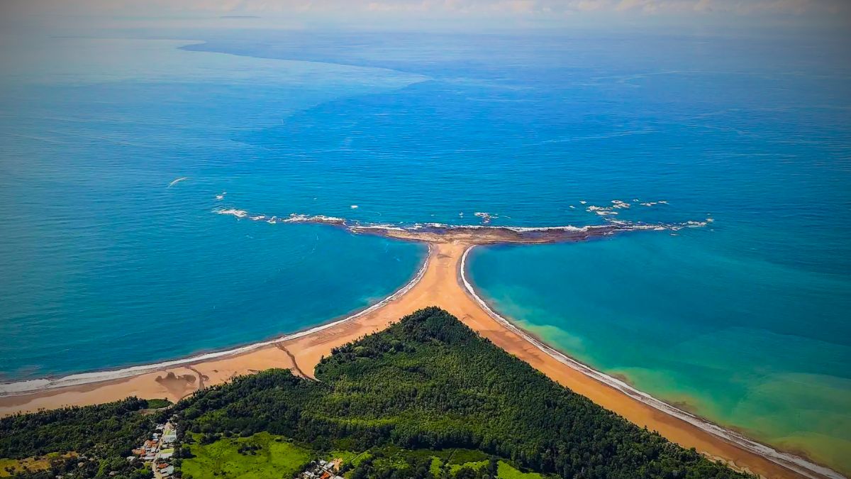Aerial view of famous whale tail shaped sandbar formation at Marino Ballena National Park in Costa Rica with crystal clear turquoise water and pristine coastline