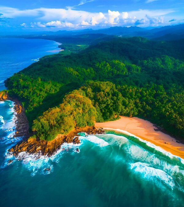 Aerial view of Osa Peninsula showing pristine tropical beach meeting lush rainforest jungle with turquoise ocean waters in Costa Rica